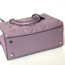 Load image into Gallery viewer, Purple handbag with textured surface and silver studs on a white background