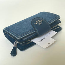 Load image into Gallery viewer, Blue wallet with Coach logo on a white background