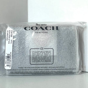 Coach New York pouch in clear packaging on a white background