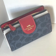 Load image into Gallery viewer, Coach wallet with red flap on a white background