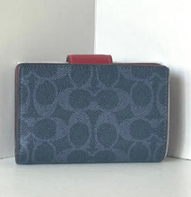 Load image into Gallery viewer, Blue patterned clutch bag with a red strap on a white background