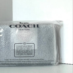 Coach New York pouch in clear packaging on a white background