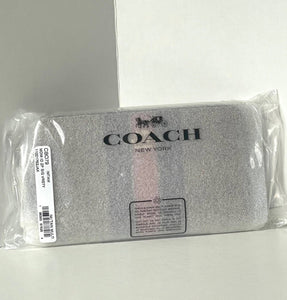 Coach wallet in packaging on a light gray background