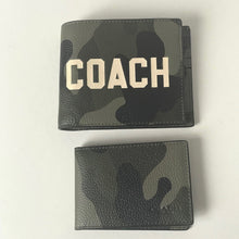 Load image into Gallery viewer, Two camouflage-patterned wallets, one plain and one with 'COACH' branding, on a light gray background.
