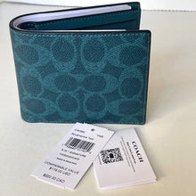 Load image into Gallery viewer, Teal wallet with Coach branding and tags on a light background