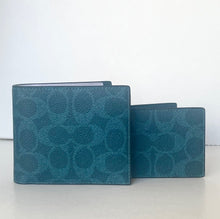 Load image into Gallery viewer, Two teal patterned wallets on a white surface with a light gray background
