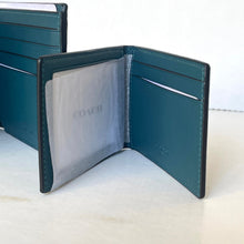 Load image into Gallery viewer, Blue leather wallet with 'Coach' branding on a light background