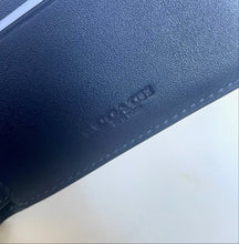 Load image into Gallery viewer, Close-up of a blue leather wallet with 'Kerr &amp; Co' branding on a light background