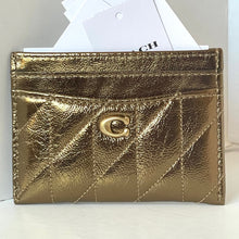 Load image into Gallery viewer, Gold quilted wallet with a brand logo on a white background