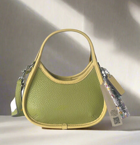 coach leather Green handbag with a visible brand tag on a white background