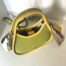 Load image into Gallery viewer, coach Green handbag with a visible brand tag on a white surface
