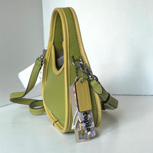 Load image into Gallery viewer, coach mini Green leather handbag with a tag on a white surface