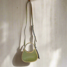 Load image into Gallery viewer, Green leather handbag with a strap on a white background
