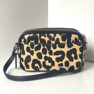 Leopard print handbag with navy accents on a white background