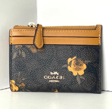 Load image into Gallery viewer, Coach wallet with gold accents on a white background