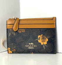 Load image into Gallery viewer, Coach wallet with floral design on a white background