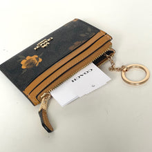 Load image into Gallery viewer, Coach wallet with keychain on a white background