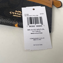 Load image into Gallery viewer, Coach wallet with a price tag on a light gray background
