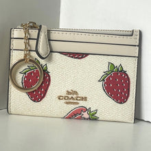 Load image into Gallery viewer, Coach cardholder with strawberry pattern and keychain on a neutral background