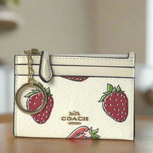 Load image into Gallery viewer, Coach cardholder with strawberry design and keychain on a neutral background