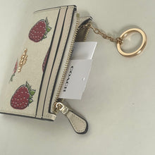 Load image into Gallery viewer, Small wallet with strawberry pattern and keychain, featuring a Coach tag on a light background