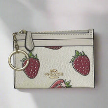 Load image into Gallery viewer, Coach cardholder with strawberry pattern and keychain on a light gray background