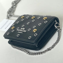 Load image into Gallery viewer, Black leather wallet with grommet details and chain strap on a white background