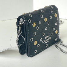 Load image into Gallery viewer, Blue Coach handbag with gold and silver studs on a white background
