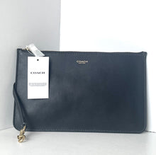 Load image into Gallery viewer, Navy blue Coach clutch bag with a tag on a white background