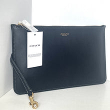 Load image into Gallery viewer, Navy Coach clutch bag with a tag on a white background