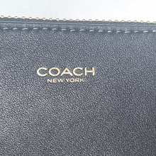 Load image into Gallery viewer, Close-up of a Coach wallet with visible branding.