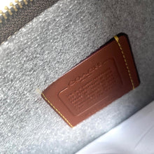Load image into Gallery viewer, Brown leather label with text on a textured surface