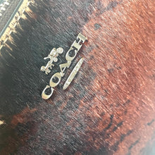 Load image into Gallery viewer, Coach logo on a wooden surface