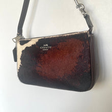 Load image into Gallery viewer, Coach handbag with brown and black pattern on a white background