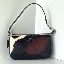 Load image into Gallery viewer, Coach handbag with cow print pattern on a white background