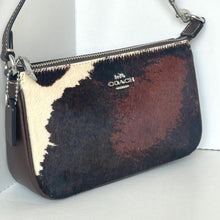 Load image into Gallery viewer, Coach handbag with cowhide pattern on a white background
