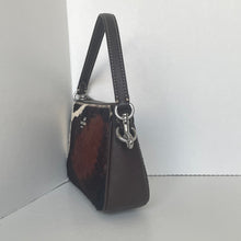Load image into Gallery viewer, Black handbag with a cowhide pattern on a white background