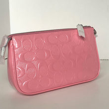 Load image into Gallery viewer, Pink textured pouch with a zipper on a light gray background