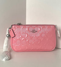 Load image into Gallery viewer, Pink Coach wallet with a strap on a light gray surface