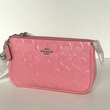 Load image into Gallery viewer, Pink Coach wristlet with silver accents on a white background