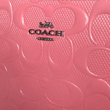 Load image into Gallery viewer, Close-up of a pink Coach product with embossed design