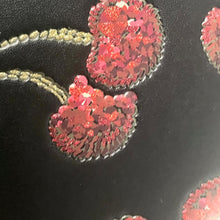 Load image into Gallery viewer, Close-up of red floral embroidery on black fabric