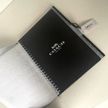 Load image into Gallery viewer, Black notebook with a brand logo on a white surface