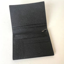 Load image into Gallery viewer, Black leather wallet on a light beige background