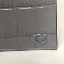 Load image into Gallery viewer, Close-up of a gray textured wallet with a brand logo on a white background