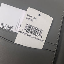 Load image into Gallery viewer, Close-up of a gray passport case with a label and barcode on a gray background