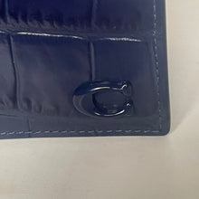 Load image into Gallery viewer, Close-up of a blue wallet with a brand logo on a light gray background