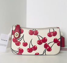 Load image into Gallery viewer, Coach handbag with cherry design on a white surface