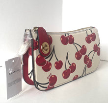 Load image into Gallery viewer, Coach wristlet with cherry pattern on a white surface
