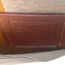 Load image into Gallery viewer, Coach bag with brand name and authenticity message on a white background